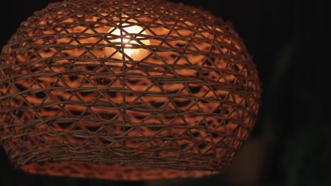 Rustic-woven-wicker-lampshade-with-warm-glowing-light