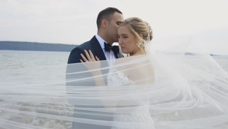 Veil-blows-in-the-window-in-front-of-couple