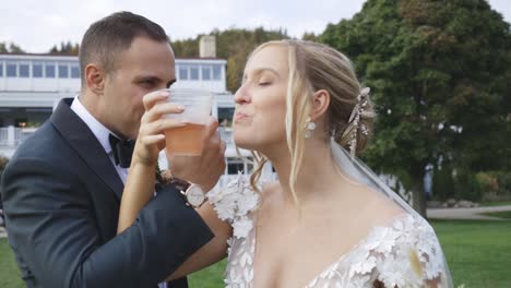 Bride-and-groom-drink-alcohol-together-celebrating