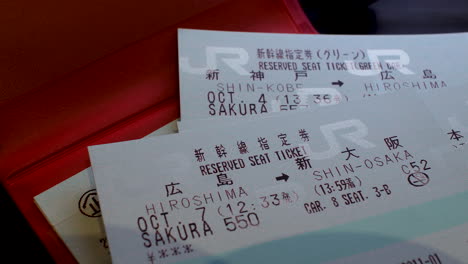 Placing-Japan-Rail-Pass-reservation-tickets-on-a-table,-symbolizes-efficient-travel-planning-and-the-convenience-of-exploring-Japan's-railways