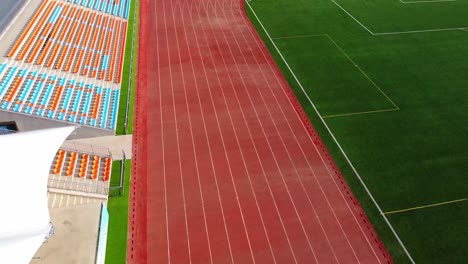 Descending-aerial-view-of-small-football-or-soccer-stadium-in-China-no-people