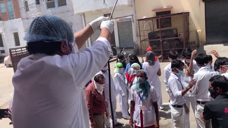 Covid-19,-Sanitation-Worker-Spraying-To-Disinfect-A-Group-Of-Doctor-To-Protect-From-Coronavirus-Spread