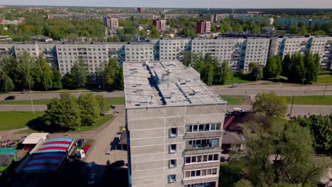 Fixed-aerial-view-of-Soviet-era-apartment-building-blocks-with-street-traffic-passing-by