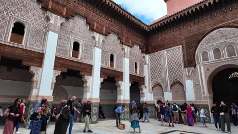 Medersa-Ben-Youssef-with-tourists-visiting-in-Marrakech-Morocco