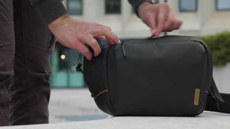 person-packs-folded-quadcopter-drone-and-puts-it-into-camera-bag