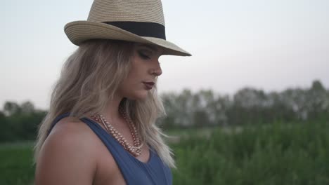 A-Sexy-Lady-Striking-A-Pose-In-The-Green-Grass-With-Trees-In-The-Background-Under-Bright-Sky-In-Ontario