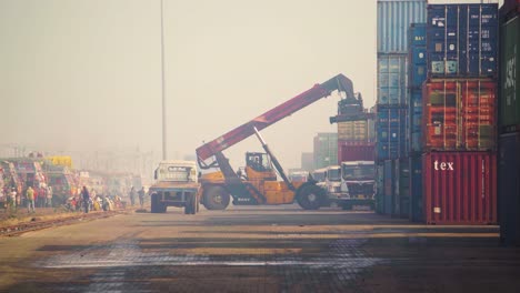 A-Handler-crane-loading-a-Large-Storage-Container-on-a-carriage-truck-at-a-dry-train-railway-port