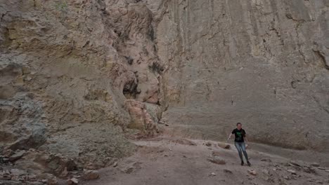 Visitor-carefully-descends-rocky-underground-Eyes-of-God-karst-cave