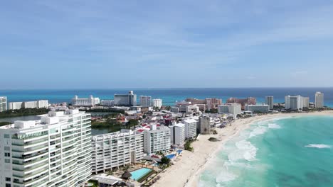 Flying-up-from-the-sea-and-showing-the-hotels-over-the-coast-in-Cancun,-Mexico