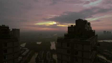 Aerial-view-of-Hanoi's-high-rise-buildings-under-a-misty,-cloudy-sky,-illustrating-the-blend-of-urban-development-and-atmospheric-ambiance