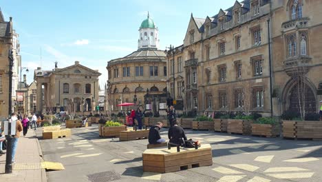 Vista-Urbana-Panorámica-De-Las-Calles-Peatonales-De-La-Ciudad-De-Oxford-Con-El-Teatro-Sheldonian-Y-Edificios-Históricos-De-Diseño-Arquitectónico-En-Inglaterra,-Reino-Unido