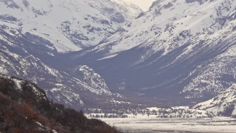 Scenic-winter-view-of-river-valley-and-snow-capped-mountains-in-Patagonia,-El-Chalten,-Argentina