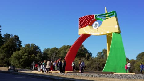 Tourists-visiting-a-colorful-sundial-during-a-winter-day-with-clear-blue-sky