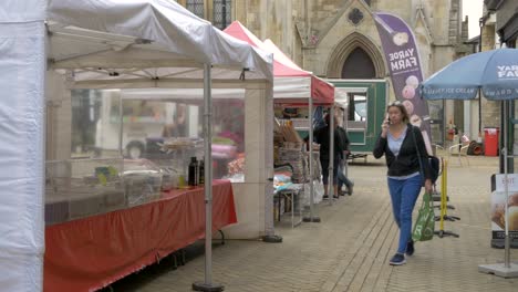 UK-Saturday-Market-in-front-of-Church,-social-distancing-in-place