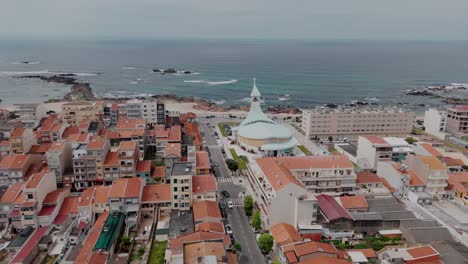 Aerial-view-of-Igreja-Nosso-Senhor-dos-Navegantes,-Vila-do-Conde,-Portugal-with-Atlantic-Ocean