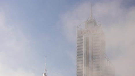 Time-lapse-of-Rio-Tinto-tower-in-Perth,-Western-Australia-with-morning-fog-dancing-around-the-building