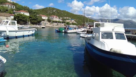 Rotating-view-of-small-boats-in-the-marina-at-Elafiti-Islands,-Croatia,-capturing-the-concept-of-maritime-charm-and-tranquil-coastal-life