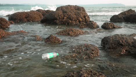 Plastic-bottle-floats-among-rocks-in-a-polluted-ocean-scene