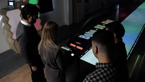 Slow-orbiting-shot-of-a-group-setting-up-the-profiles-to-play-ten-pin-bowling