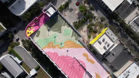 Aerial-view-above-the-artsy-design-district,-museum-garage,-parking-lot,-in-Wynwood,-Miami---screwdriver,-drone-shot