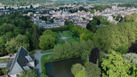 Aerial-view-of-Coulommiers,-a-charming-town-near-Paris,-France,-showcasing-lush-greenery-and-historical-architecture