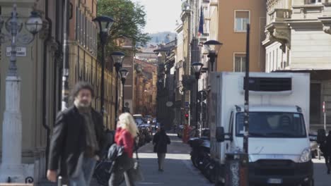 People-walking-in-street-of-Bologna,-static-view