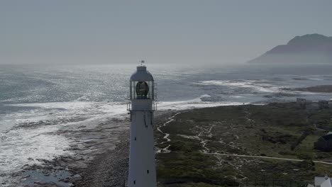 Pull-Back-Aerial-Shot-Slangkop-Lighthouse-Kommetjie,-Western-Cape,-South-Africa