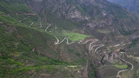 Aerial-flyover-of-switchback-road-in-rustic-valley-below-Tatev-Armenia