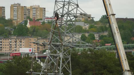 The-workers-work-on-a-high-voltage-pole-installation-in-the-city