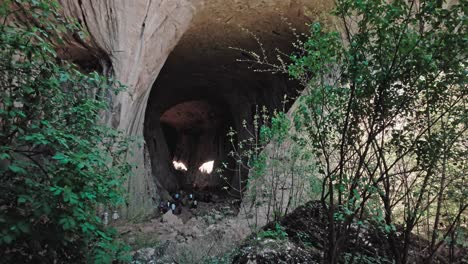 Natural-sunlight-shines-like-two-eyes-inside-natural-cave-formation