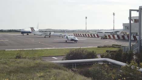 Static-wide-shot-of-Pula-Airport-with-parking-luxury-cessna-citation,propeller-aircraft-and-boing-airplane