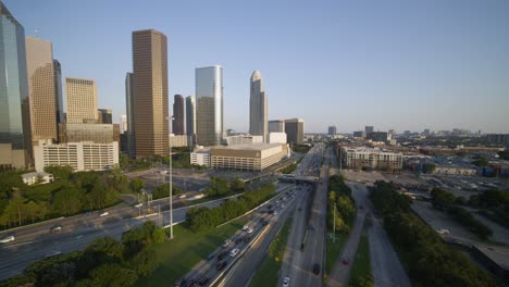 Wide-angle-push-in-shot-of-downtown-Houston-and-cars-on-I-45-freeway