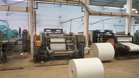 The-prepared-rolls-are-kept-inside-the-big-machine,-paper-are-cut-and-poured