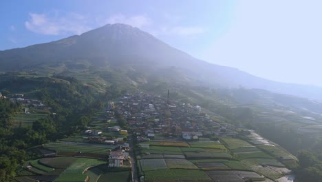 Drone-view-of-beautiful-village-and-plantation-on-the-slope-of-mountain