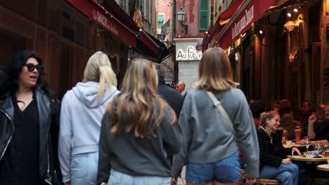 People-enjoy-outdoor-cafes-and-narrow-streets-in-Nice,-France,-static-view