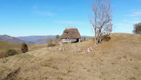 Drone-footage-of-an-old-Romanian-traditional-house,-flying-from-outside-to-inside-of-the-house