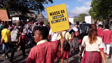 Students-gathering,-marching-and-holding-climate-change-sign