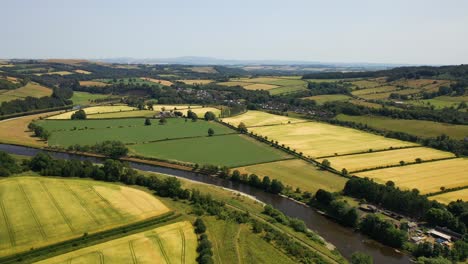 Aerial-of-lush-green-countryside-of-the-Scottish-Borders,-rural-farming-town-of-Melrose