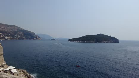 Panoramic-vista-of-the-sea,-islands,-and-City-Walls-of-Dubrovnik,-Croatia,-capturing-the-concept-of-serene-coastal-beauty-and-historical-grandeur