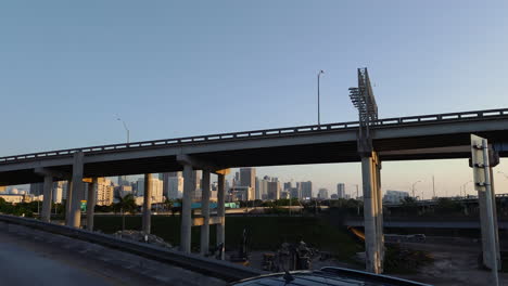 Cars-on-highway-bridge-in-front-of-Miami-skyline-at-sunset