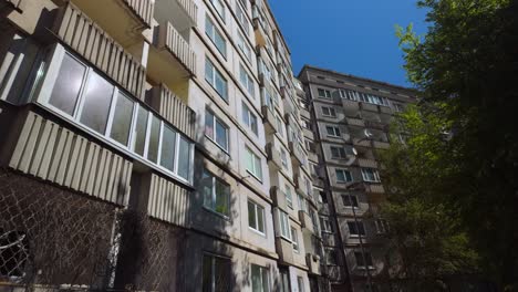 Fixed-shot-of-a-Soviet-apartment-block-with-windows-and-balconies-on-a-sunny-day