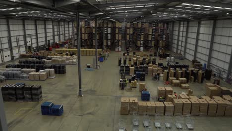 Birds-eye-view,-Left-to-right-pan-of-large-dispatch-warehouse