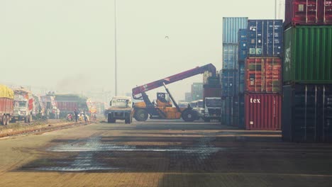 A-Handler-crane-loading-a-Large-Storage-Container-on-a-carriage-truck-at-a-dry-train-railway-port-in-Madhya-Pradesh-India