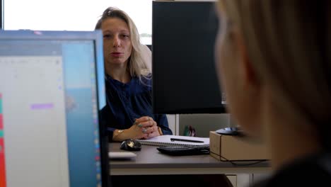 Slow-motion-shot-of-office-workers-speaking-with-each-other-in-the-office