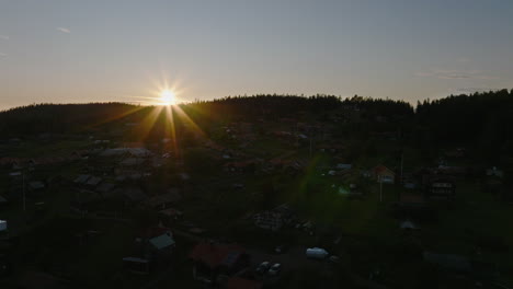 Dolly-right-drone-aerial-view-of-sunset-small-village-Sweden