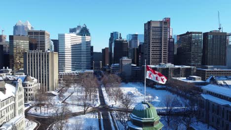 Aerial-Clip-of-McGill-University's-Flag-Waving-on-Cold-Winter-Day-with-Ice-Hockey-Players-in-the-Background-in-Montreal