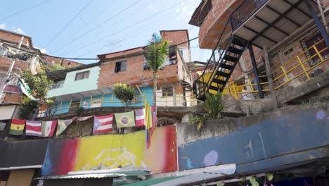 Vibrant-hillside-view-in-Medellin's-Comuna-13-with-colorful-houses-and-flags