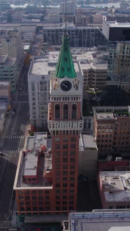 Vertical-Aerial-View-of-Tribune-Tower-in-Downtown-Oakland,-California-USA,-Historic-Landmark,-Drone-Shot