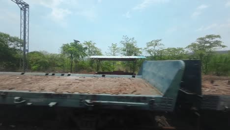 empty-goods-train-closeup-from-train-window-view