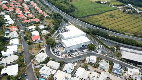 Aerial-drone-flight-over-a-Renault-car-dealership-and-repair-centre-in-Saint-Pierre,-Reunion-Island